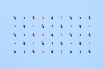 Medicine concept.  Pink capsule and hard pills