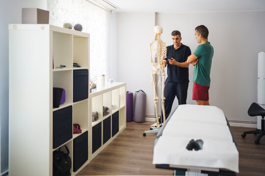 A physiotherapist explaining to a patient