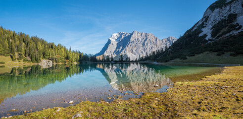 morning scenery lake Seebensee, alpine landscape with view to Zugspitze mountain and water reflection