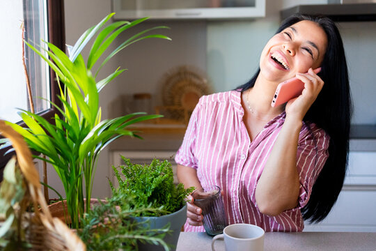 Paraguayan woman very happy calling by phone at home