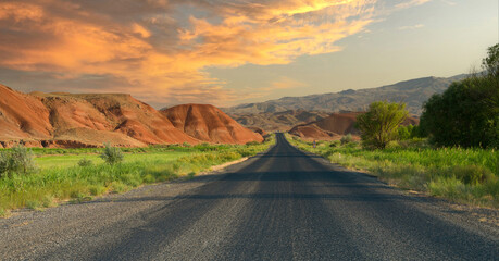 Straight road at dramatic sunset