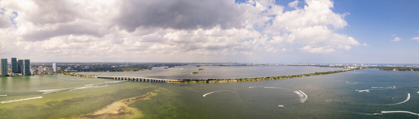 Fototapeta na wymiar Aerial photo Miami scenes. Includes bridges over bay and cloudy sky