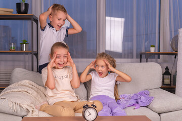 the alarm clock rings, the children scream and do not want to go to school