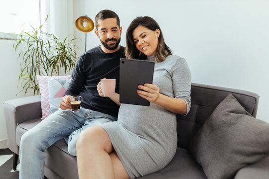 Adult couple expecting a baby spending time together at home. - Powered by Adobe