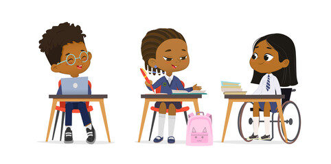Cute primary pupils studying at diverse inclusion school wearing uniform at lesson vector flat illustration. Dark skin girl in wheelchair talking with multiracial classmates at table isolated on white