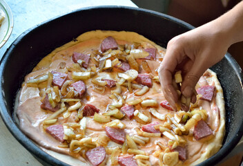 cooking pizza at home in the kitchen, close-up