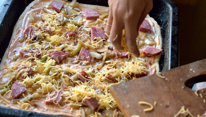 cooking pizza at home in the kitchen, close-up