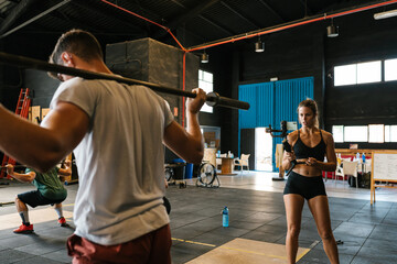 Female athlete recording video for fitness blog