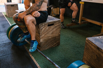 Unrecognizable tattooed athlete at the gym