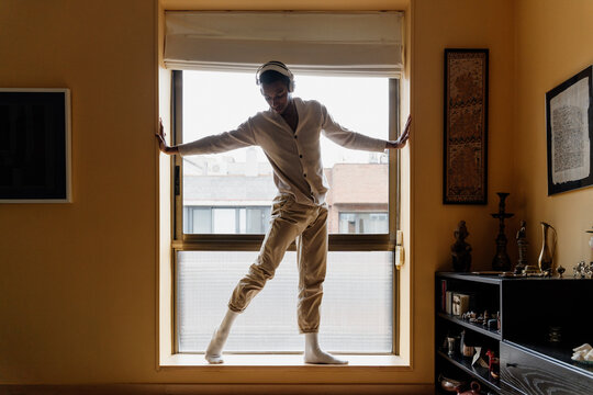 Young man relaxing at home - Powered by Adobe