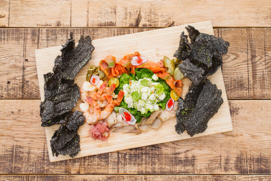 Fresh seafood platter on wooden table.