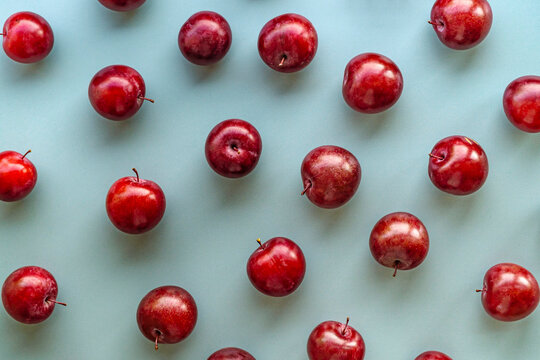 red Plums on blue background