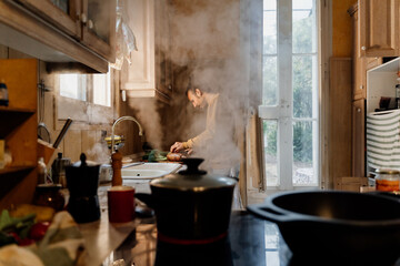 YOUNG Man cooking healthy food at home