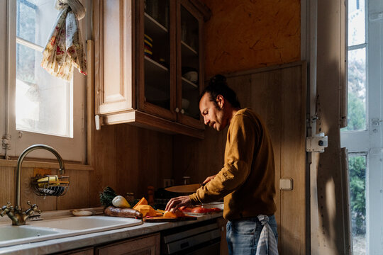 YOUNG Man cooking healthy food at home