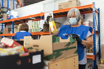 Volunteer woman preparing food packages