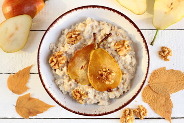 Porridge with caramelized pear and walnuts. Nutritious autumn breakfast