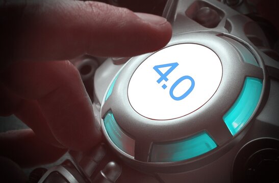 Finger about to press a car ignition button with the numbers "4.0". Composite image between a hand photography and a 3D background. Concept of Industry 4.0.