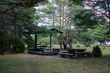 Rusty barbecue oven in an outdoor grilling house in forest. Beautifully designed old grill equipment in outdoor kitchen.