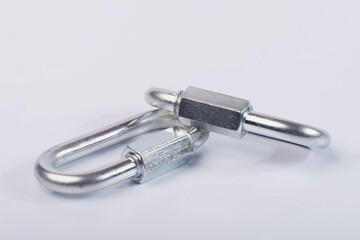 Metal snap hooks on a white isolated background.Spring carabiner made of stainless steel, heavy duty carabiner with quick release lock. 