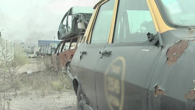 Abandoned Taxi Cab and Wrecked Cars in a Junkyard, Buenos Aires, Argentina