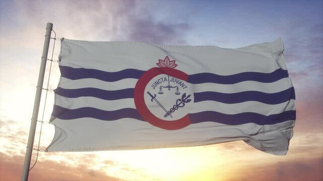 Cincinnati city of Ohio flag waving in the wind, sky and sun background