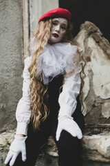 The girl with makeup of the mime. improvisation. Suit for Halloween. mime shows different emotions. Sad clown