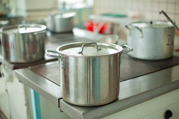 Large pot for cooking. Kitchen utensils in the dining room. Stainless steel water tank.