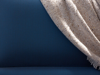 Soft gray blanket on blue couch back