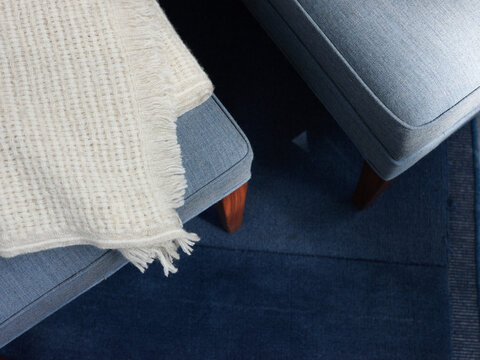 Blue couch and chair with soft blanket