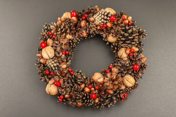 Autumn wreath of cones, nuts, and berries. Creative composition, the handmade