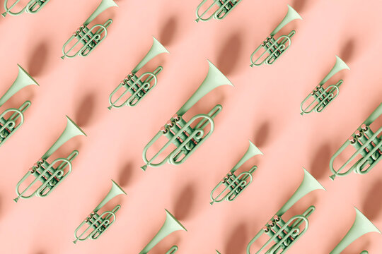 Green trumpets in different sizes on pink background