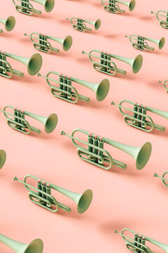 Green trumpets in different sizes on pink background