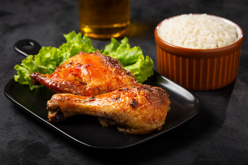 Roasted chicken pieces with lettuce salad.