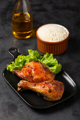 Roasted chicken pieces with lettuce salad.