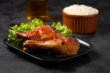 Roasted chicken pieces with lettuce salad.