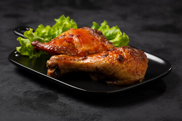 Roasted chicken pieces with lettuce salad.