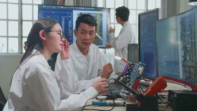 Modern Electronics Development Facility: Asian Team Of Multi Engineers, Scientists Work On Computer, Talk, Design Pcb, New Generation Silicon Microchips, Manufacturing Semiconductors
