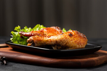 Roasted chicken pieces with lettuce salad.