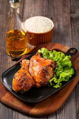 Roasted chicken pieces with lettuce salad.