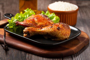 Roasted chicken pieces with lettuce salad.