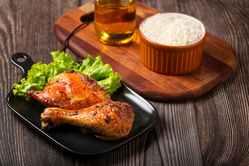 Roasted chicken pieces with lettuce salad.