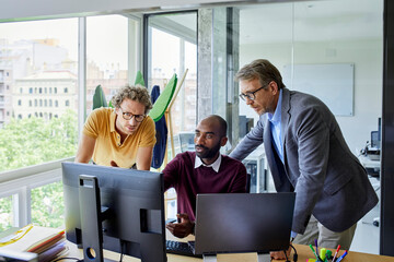 Businessmen looking at computer screen