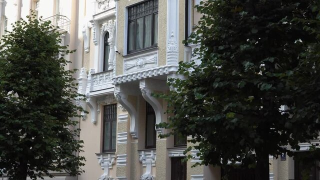 Renovated famous Jugendstil in other words Art Nouveau building facade sample in Riga, Latvia with a close-up view of wall decors, pillars, and the window box design.