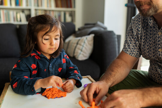 Father and daughter playing at home