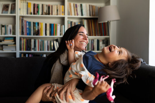Naklejki Mother and daughter having fun at home