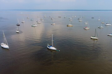 Many boats in a dock, harbor on boat floating on the ocean