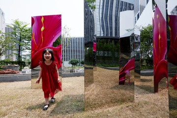 Cute Asian little girl playing on the grass in the garden outdoor.