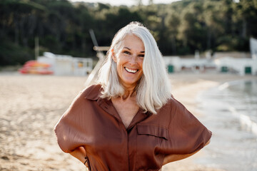 Active mature woman enjoying the beach in the morning