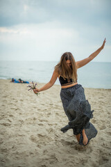 Сute teenage girl or woman on the beach nature landscape fresh air beach. Natural beauty. lifestyle/ real people/ funny/ dance.