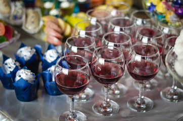 Glasses of wine alcohol red glass on a buffet table